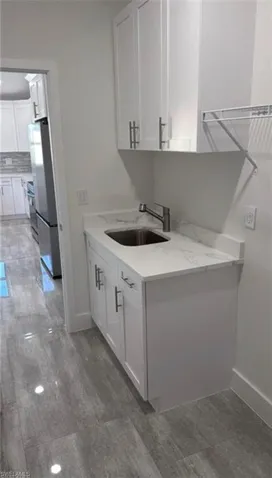 Laundry area with a sink and baseboards