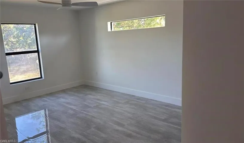 Spare room featuring baseboards and ceiling fan