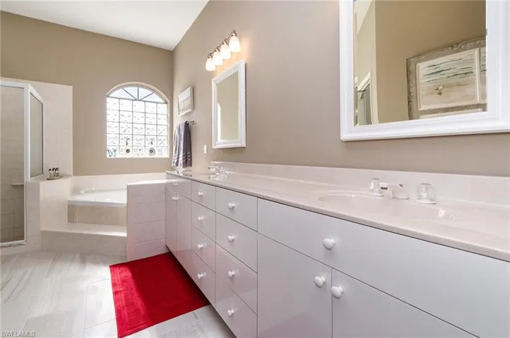 Bathroom featuring vanity, plus walk in shower, and tile flooring
