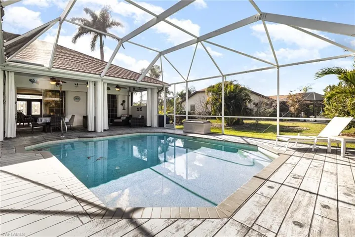 View of pool featuring ceiling fan, a lanai, and a patio