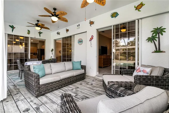 View of lanai seating with ceiling fan, outdoor lounge area, and a deck