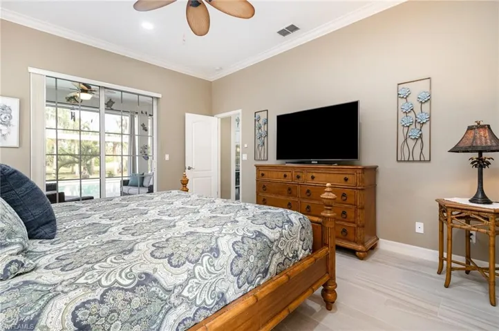 Bedroom with ceiling fan, crown molding, and access to outside