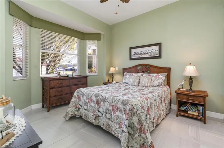 Bedroom featuring multiple windows and ceiling fan