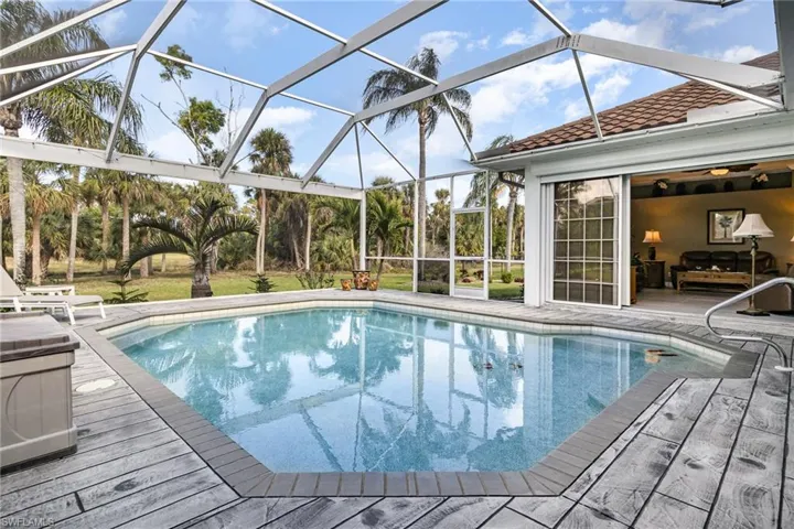 View of pool featuring glass enclosure