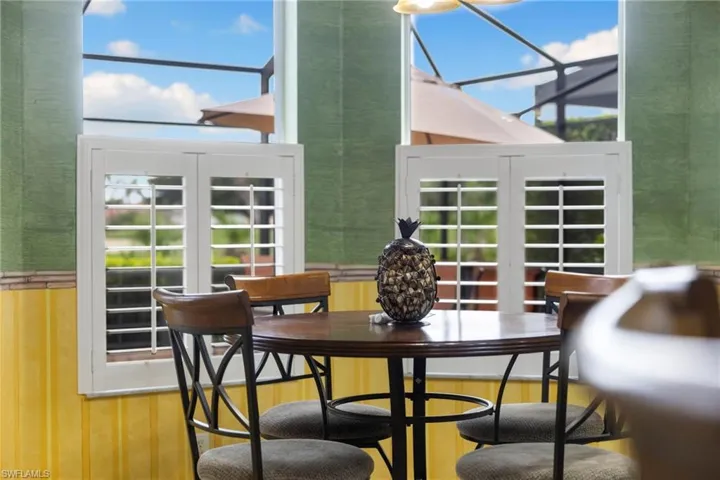 Dining space features Plantantion shutters and eat in kithcen table and counter stools stay with the home.