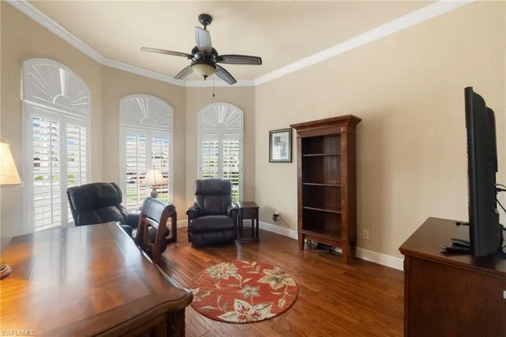 Office area with wood finished floors, 8' double glass doors, all the furniture stays and also the TV.