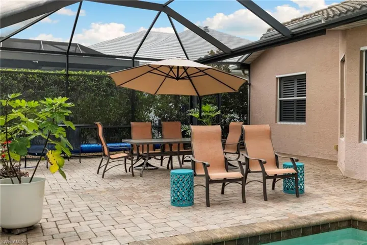 View of patio with a lanai and outdoor dining area