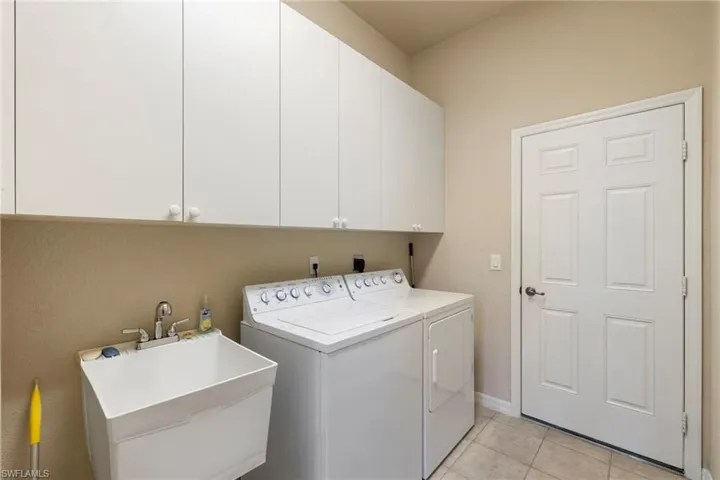 Laundry room with an industrial sink off the garage stays with the house.