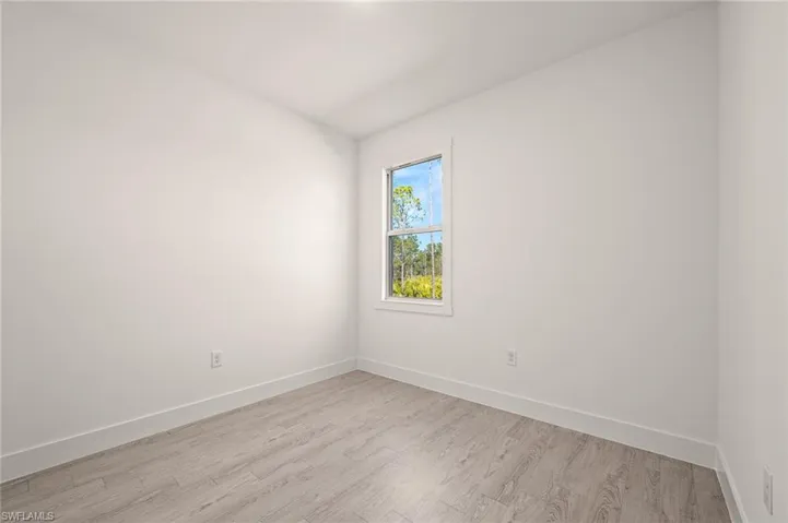 Empty room featuring light wood-type flooring and baseboards