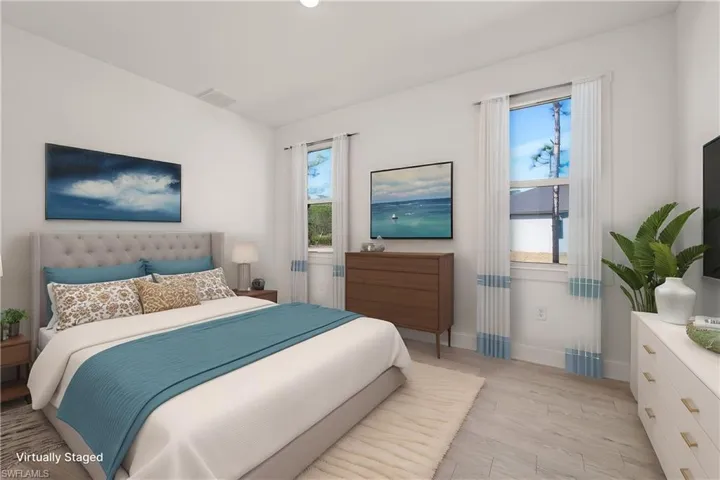 Bedroom with visible vents, light wood-style flooring, and baseboards