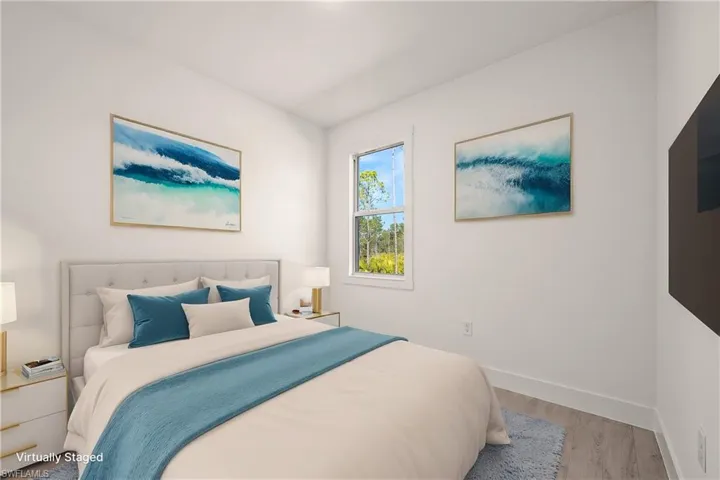 Bedroom featuring wood finished floors and baseboards