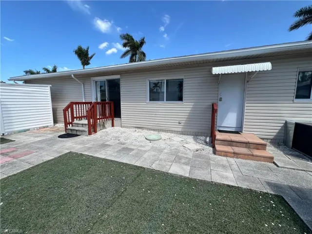 Back of house with a extra patio space.