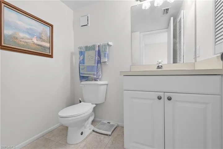 Guest bathroom featuring a white vanity