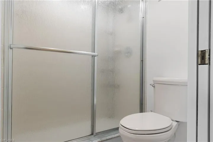 Frosted glass shower enclosure with chrome hardware