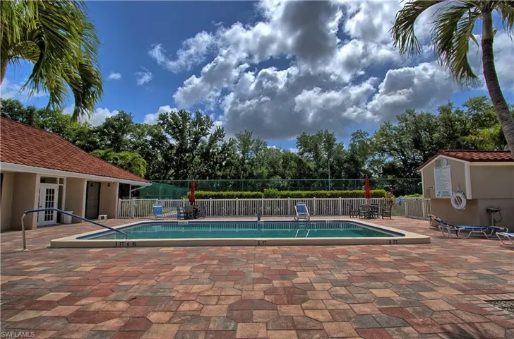 Outdoor swimming pool with integrated steps and a surrounding paver patio