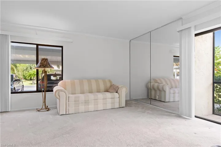 Carpeted room with a mirrored wall.