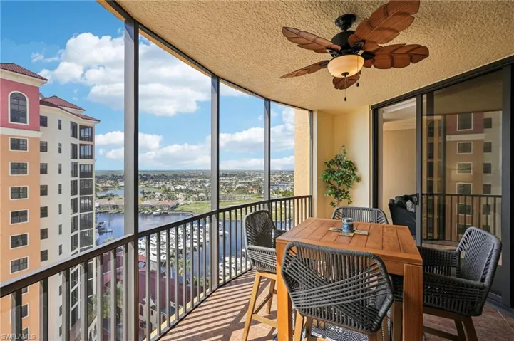 Sunroom / solarium featuring a water view and ceiling fan