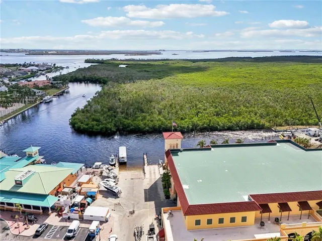 Birds eye view of property with a water view
