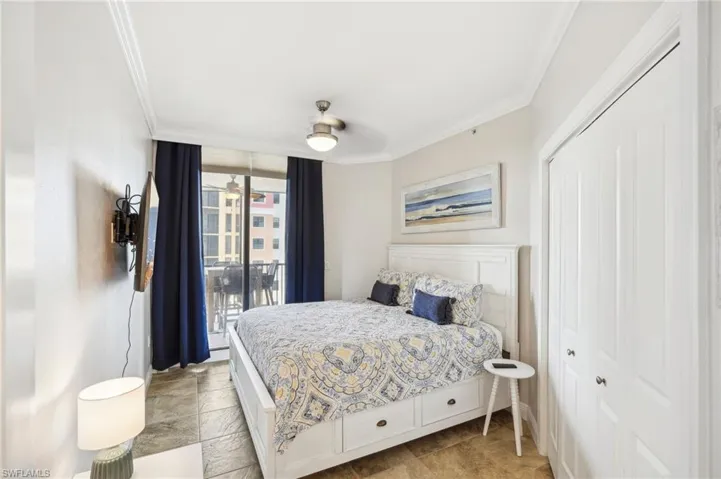 Bedroom with access to outside, a closet, ornamental molding, and ceiling fan