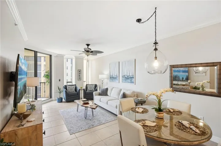Tiled living room featuring ornamental molding and ceiling fan