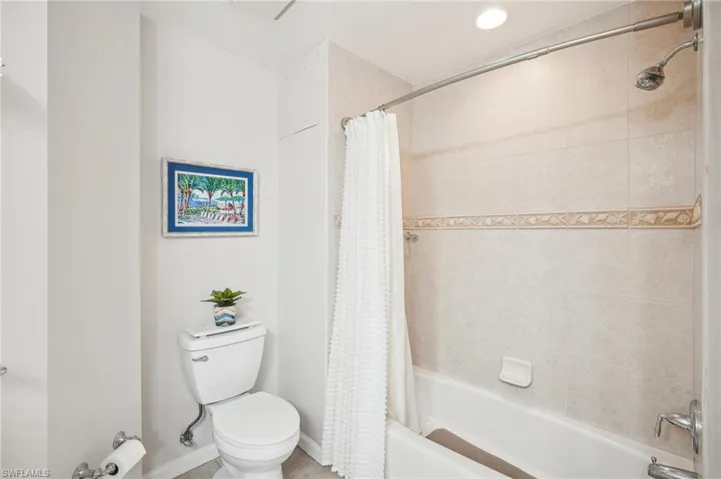 Bathroom with toilet and shower / bath combo