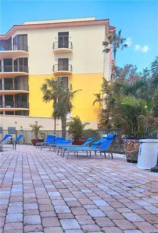 View of patio with a balcony