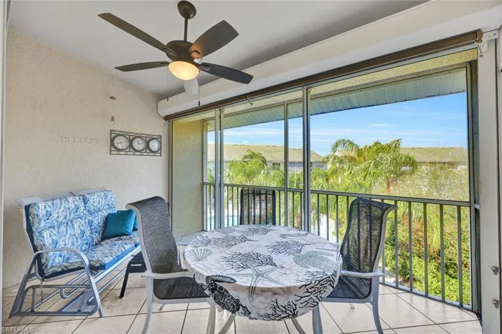Sunroom featuring ceiling fan