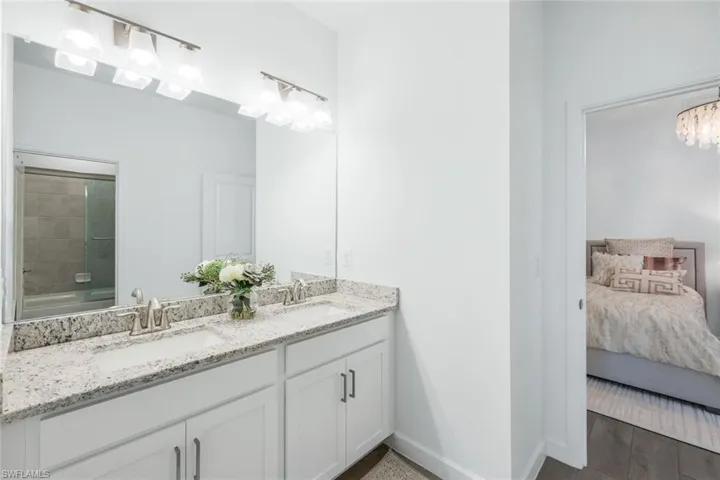 Bathroom featuring vanity and an inviting chandelier
