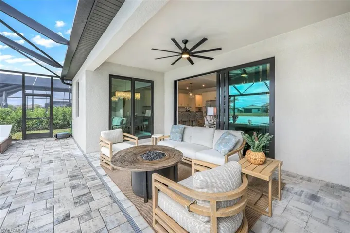 View of patio / terrace featuring an outdoor living space, a lanai, and ceiling fan