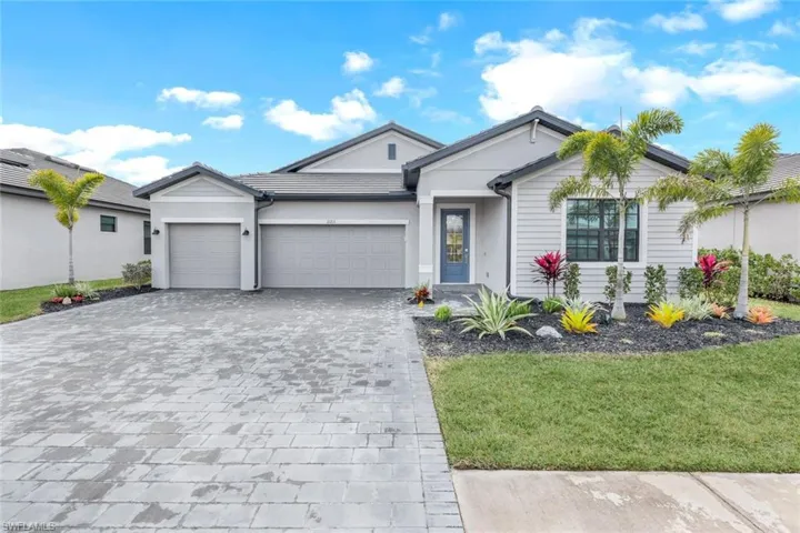 View of front facade with a garage and a front lawn