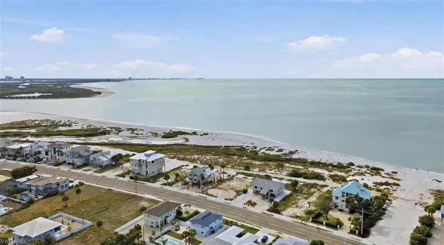Aerial perspective of suburban area featuring a large body of water