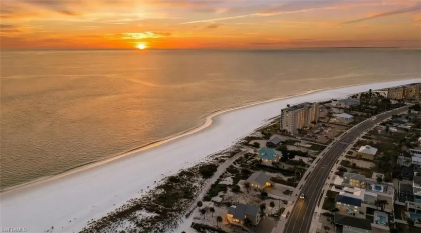 Aerial view at dusk of view of water and beach