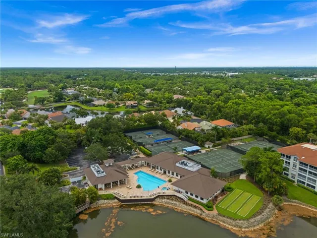 Aerial perspective showcasing a community pool, tennis courts, and bocce ball courts