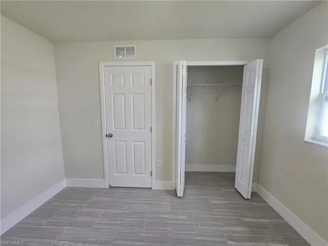 Unfurnished bedroom featuring baseboards and a closet