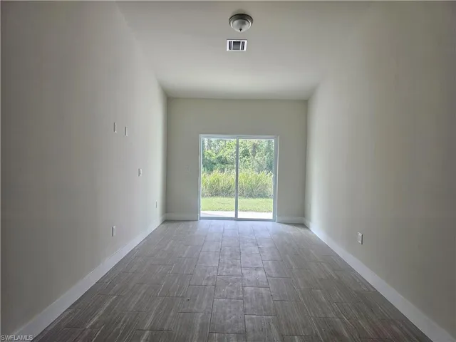 Spare room with wood tiled floors and baseboards