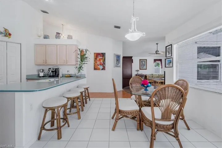 Dining space featuring a ceiling fan and light tile patterned flooring