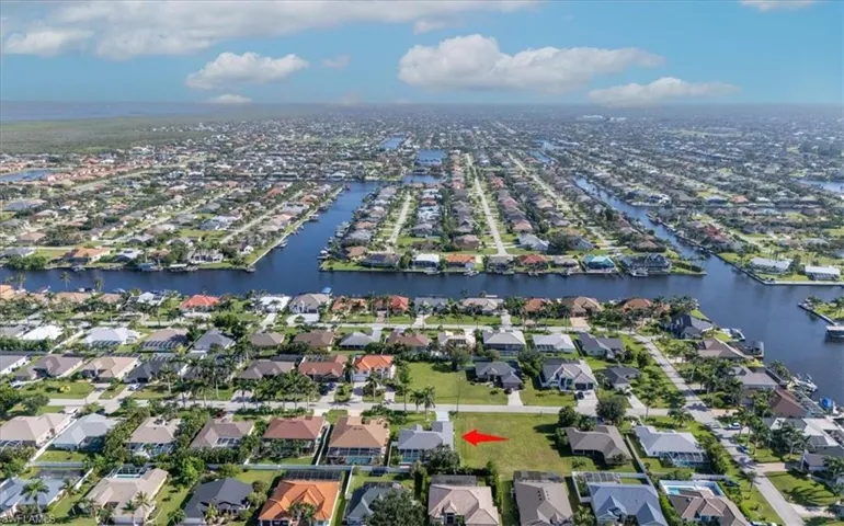 Aerial view of property's location with nearby suburban area and a large body of water