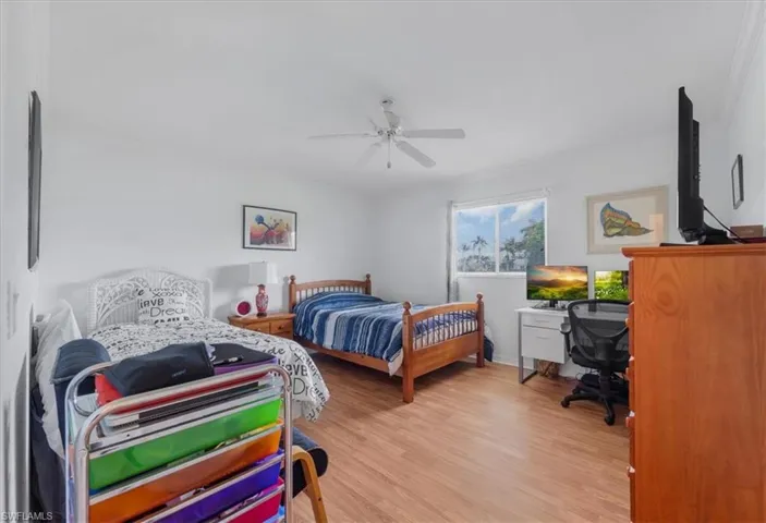 Bedroom featuring light wood-style flooring and a ceiling fan