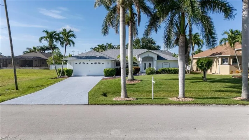 Single story home featuring an attached garage, driveway, and a front lawn