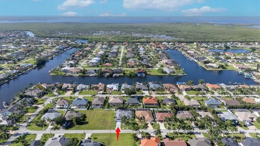 Aerial view of property's location featuring nearby suburban area and a large body of water