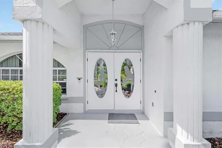 View of exterior entry featuring stucco siding