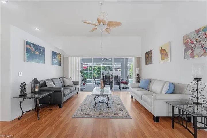 Living room with a ceiling fan, wood finished floors, and recessed lighting
