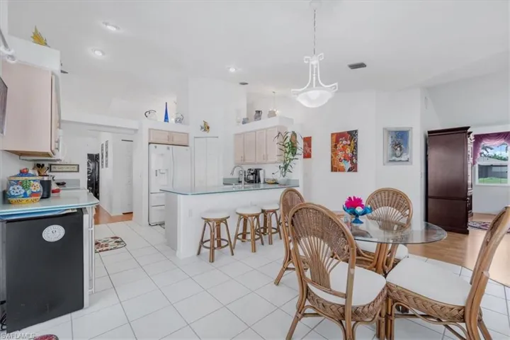 Dining room featuring light tile patterned floors and a high ceiling