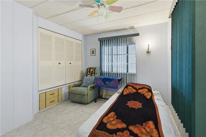 Louvered bi-fold closet doors with storage drawers beneath