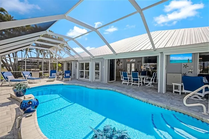 Outdoor pool featuring glass enclosure and a patio area