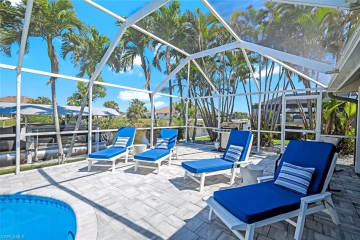 View of patio featuring a lanai
