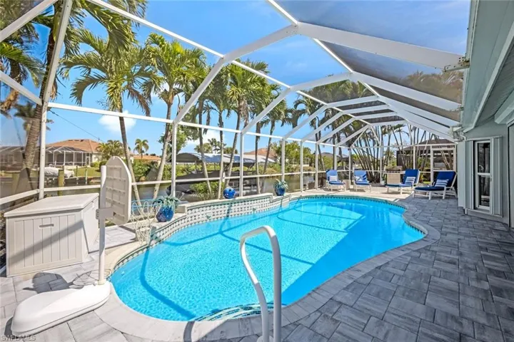 Outdoor pool featuring a patio and glass enclosure