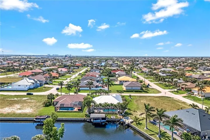 Birds eye view of property featuring a residential view and a water view