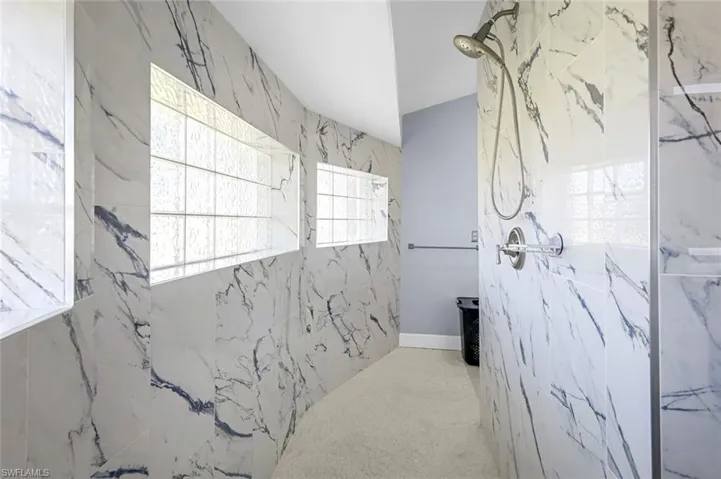 Bathroom featuring a marble finish shower