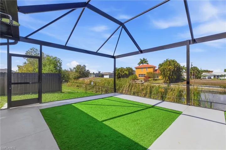 Fenced yard featuring glass enclosure, a sunroom, and a water view